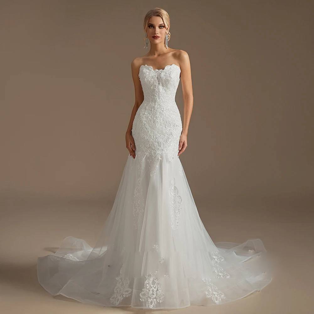 Classic front view of a slim-fit lace and tulle bridal gown with a sweetheart neckline and a floor-length trumpet flare.