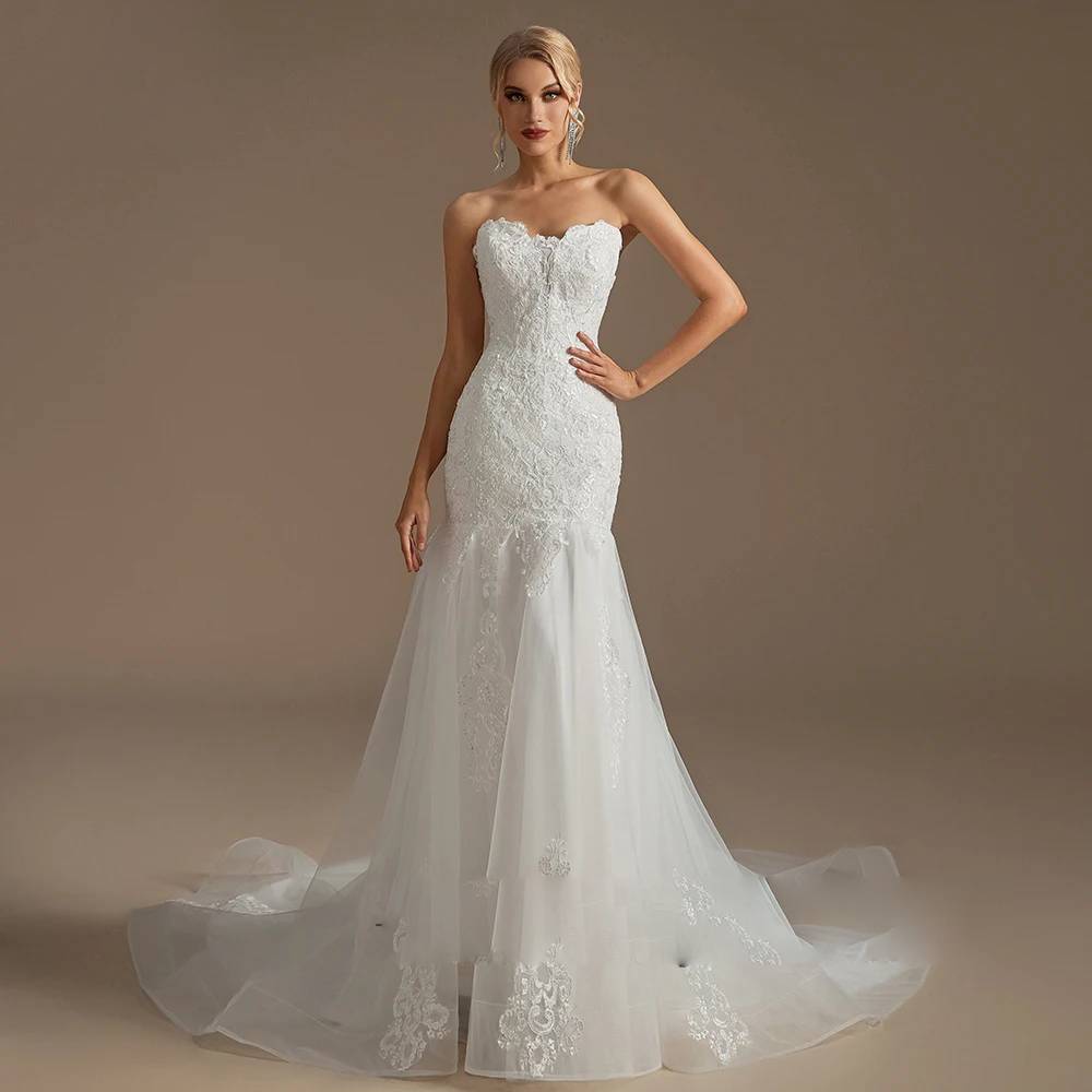 Elegant front-facing shot of a white lace mermaid wedding dress with a dramatic flared tulle skirt and structured, form-fitting bodice.