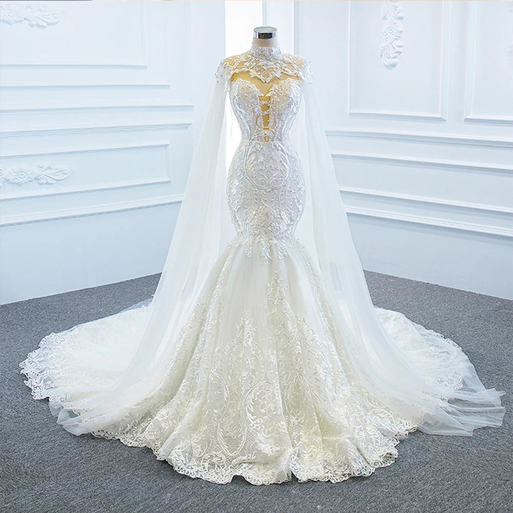 A close-up portrait of a bride in an off-the-shoulder mermaid wedding dress, highlighting the delicate lace texture and elegant shawl drape.