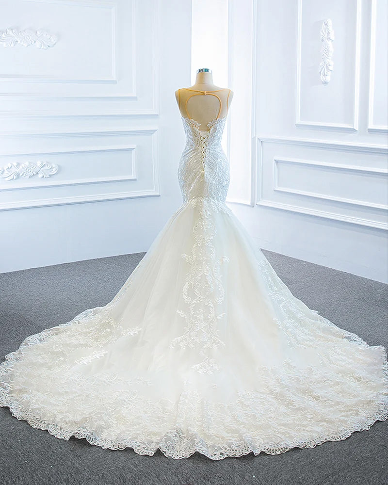 Back view of a luxury mermaid wedding dress on a mannequin, emphasizing the off-the-shoulder design and the graceful wrap of the bridal shawl.