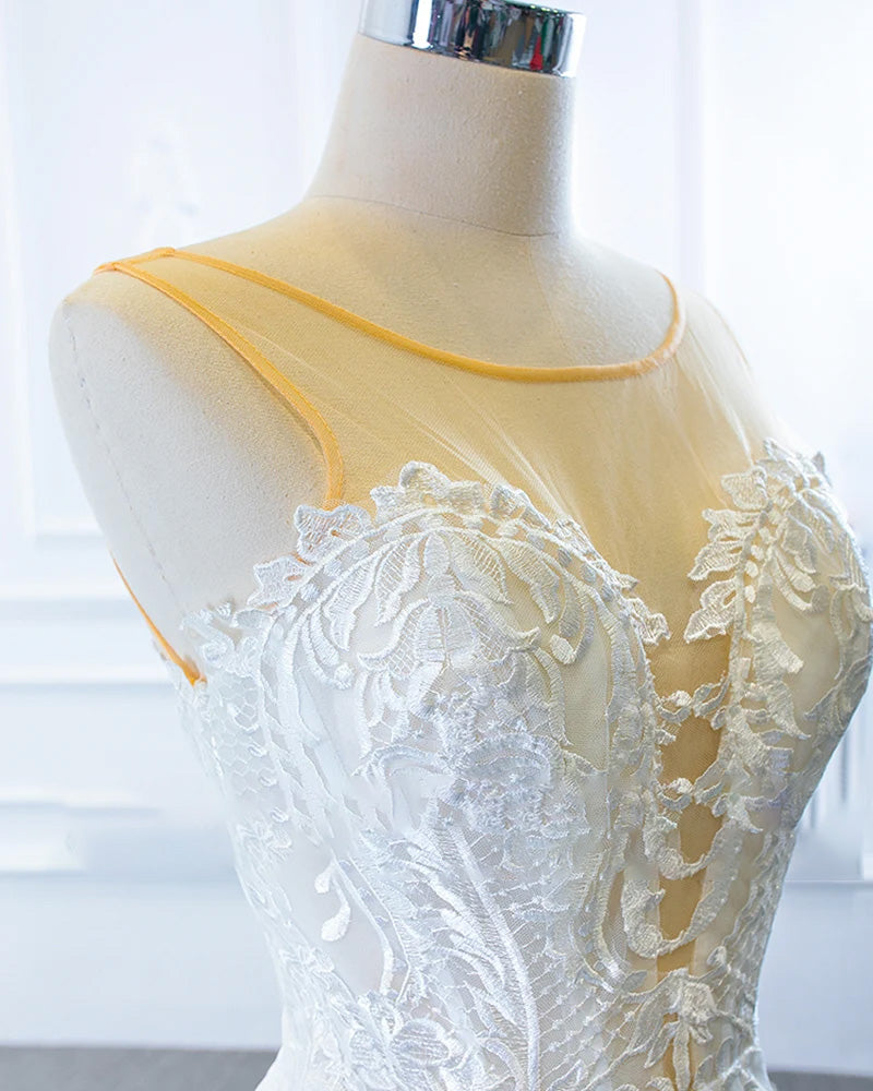 Side profile view of a mermaid wedding dress on a mannequin, showcasing the elegant fit and the versatile styling of the off-the-shoulder shawl.