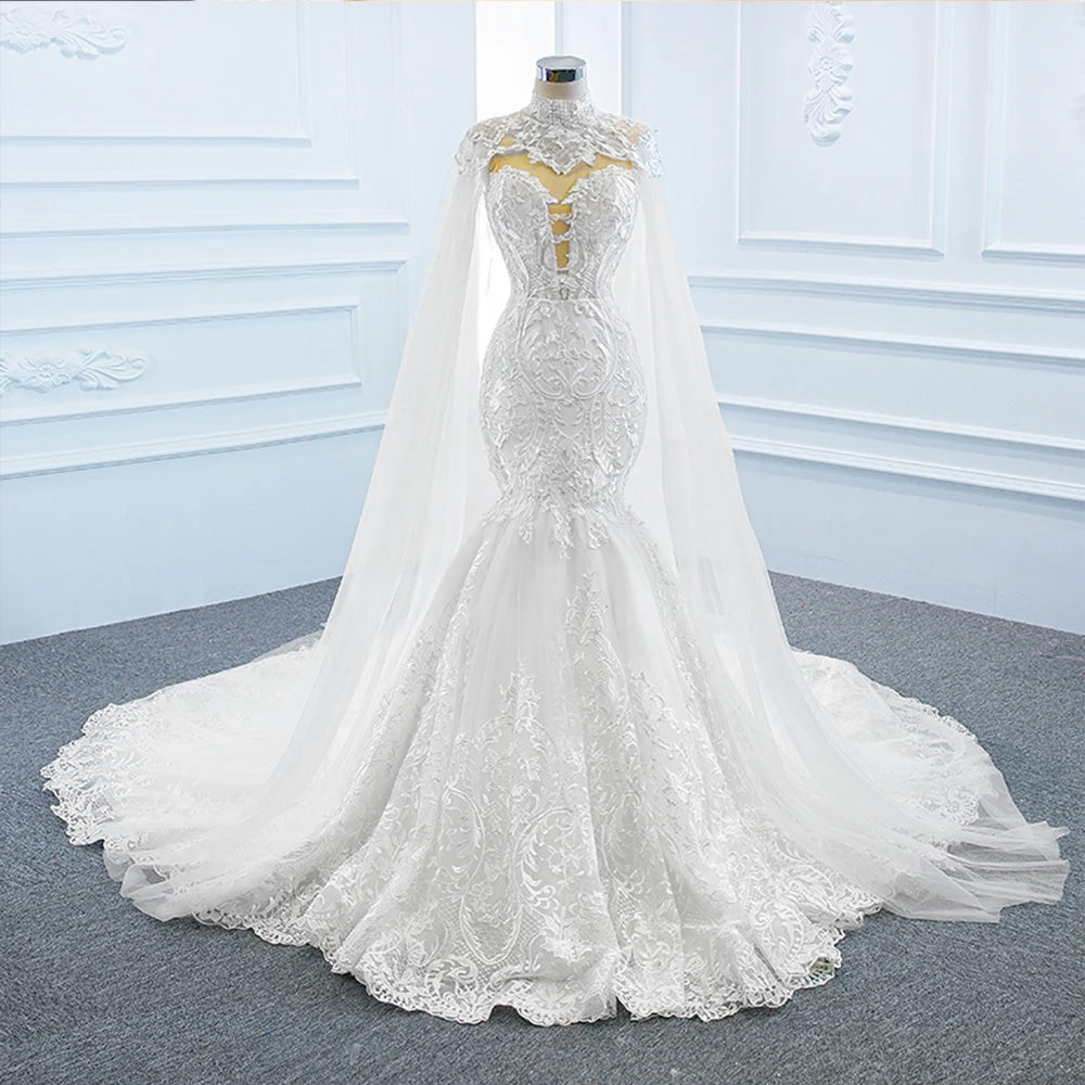 A studio mannequin presenting the front view of a luxury off-the-shoulder mermaid bridal gown with its elegant matching shawl.