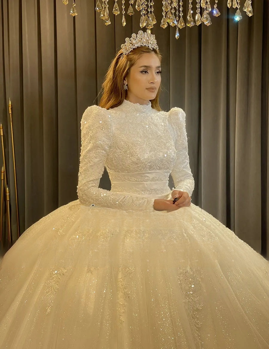 Close-up of the elegant Muslim bridal dress bodice, showcasing the modest high neckline, puffed long sleeves, and exquisite heavy beaded embroidery.
