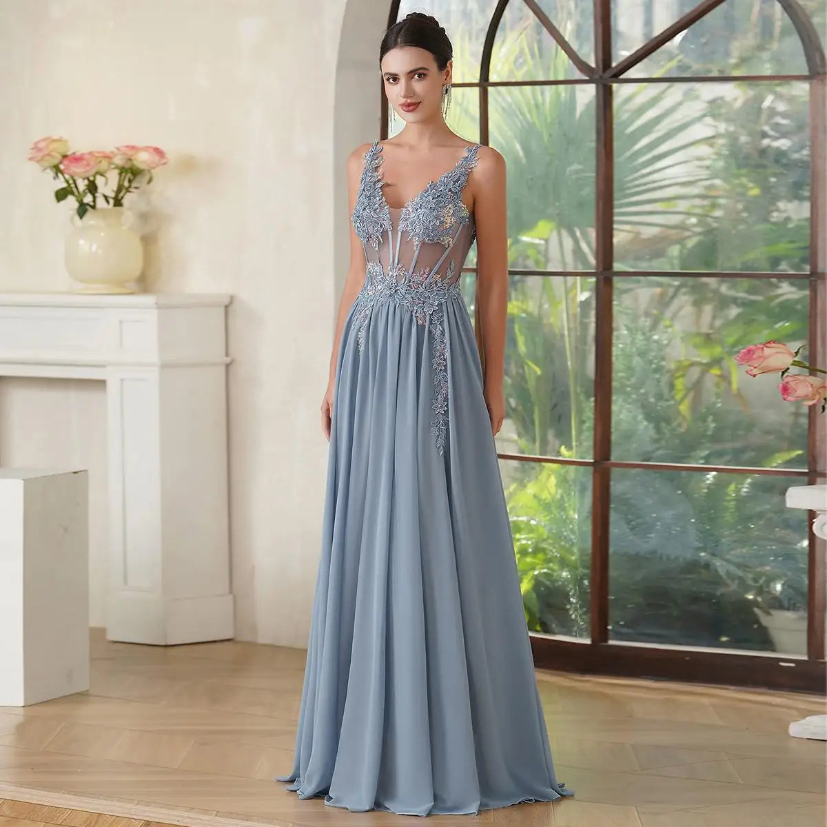 Elegant slate blue A-line evening dress featuring a sheer corset bodice with intricate beaded floral appliques and a flowy floor-length chiffon skirt.