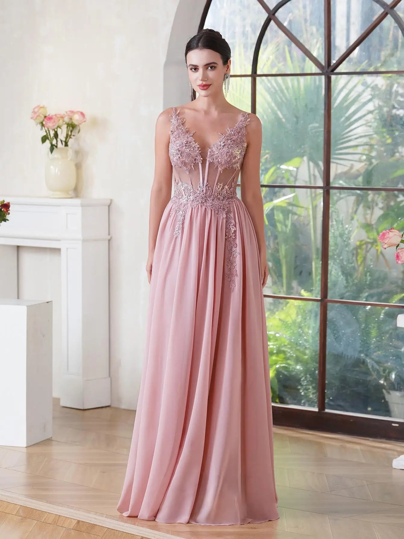 Dusty pink A-line formal gown with a sheer V-neck bodice decorated with shimmering beaded lace appliques and a sweeping floor-length skirt.