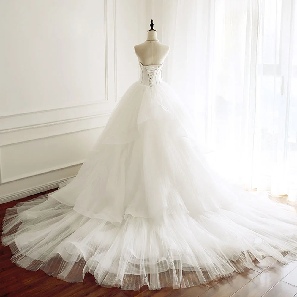 Front-facing view of a sleeveless A-line bridal gown on a mannequin, featuring a clean sweetheart neckline and flowing tulle silhouette.