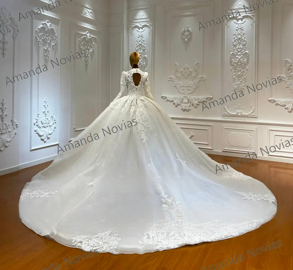 Rear view of an off-white bridal ball gown on a mannequin, highlighting an elegant keyhole back design, lace appliques, and a grand, sweeping cathedral-length train.