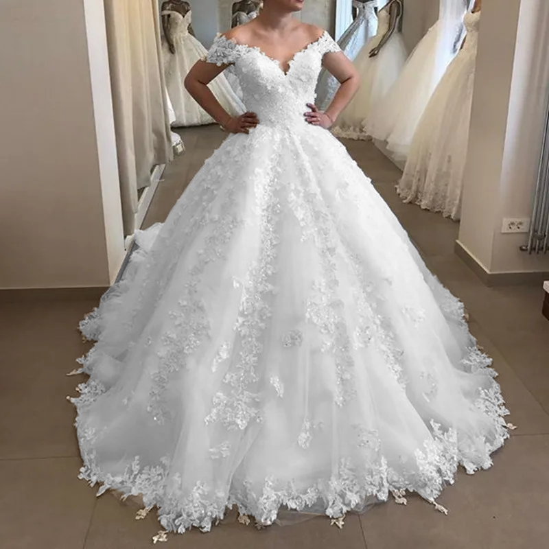 Beautiful off-shoulder ball gown bridal dress featuring a V-neck bodice, floral lace appliques, and a grand, voluminous tulle skirt.