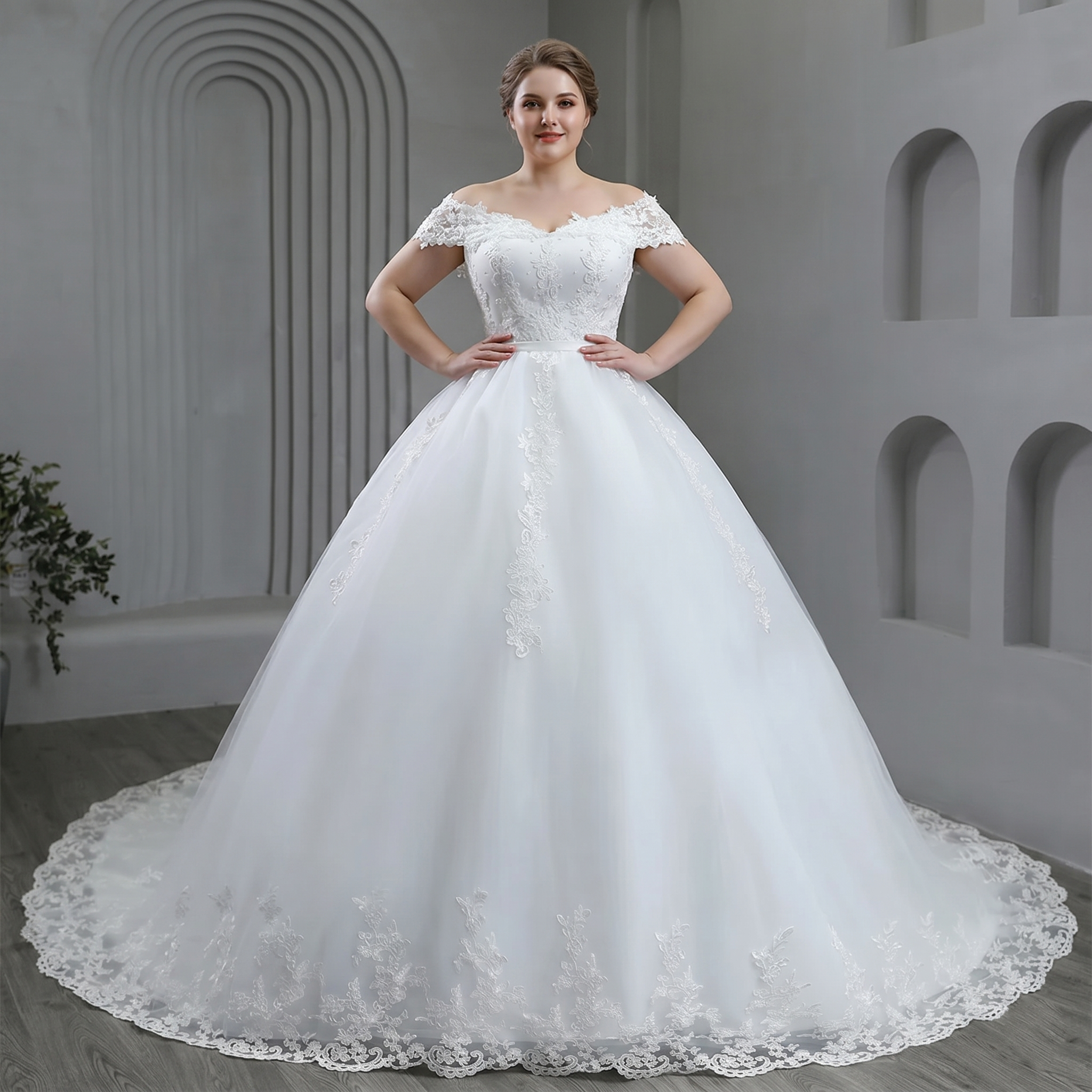 Detailed back view of the plus size off-shoulder bridal gown, showcasing an elegant low lace-up corset back design and a sweeping chapel-length tulle train.