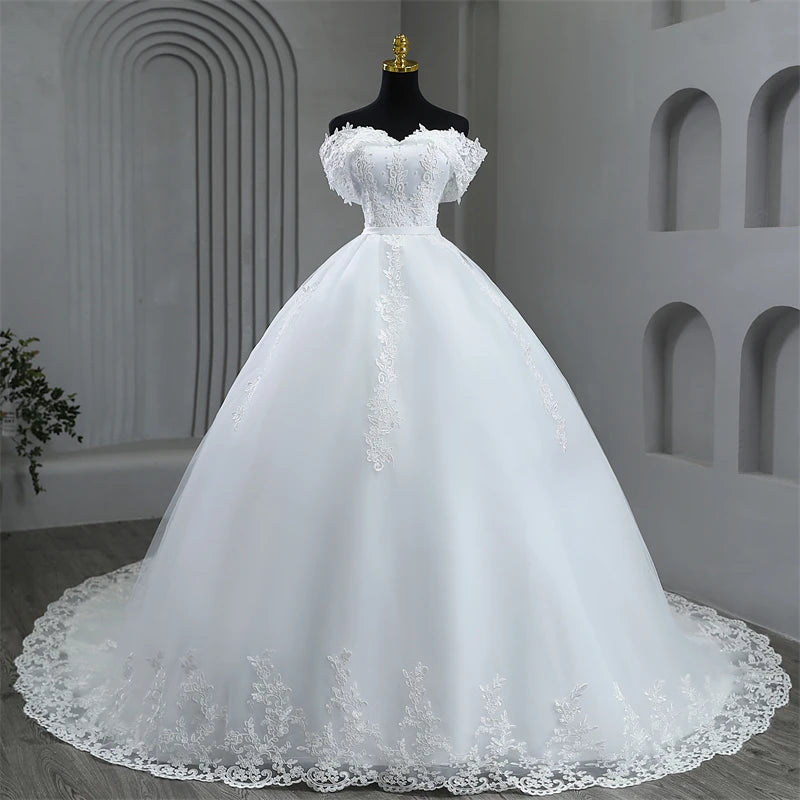 Close-up front view focusing on the intricate floral lace appliques, scattered pearls, and draped off-the-shoulder sleeves on the sweetheart corset bodice of the plus size bridal dress.