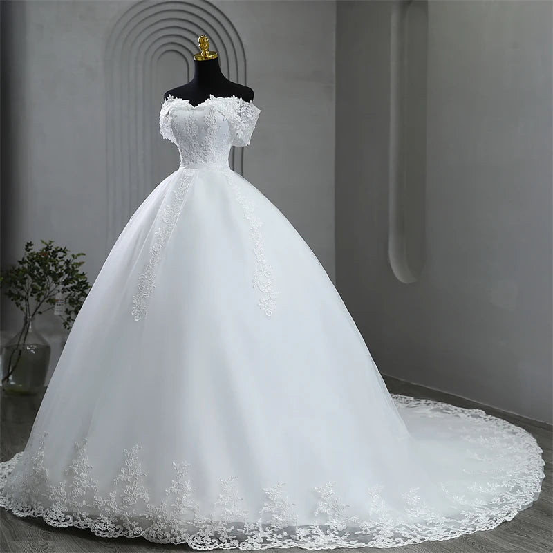 Front profile portrait of the elegant plus size off-shoulder lace wedding gown, featured in a timeless soft white color option.