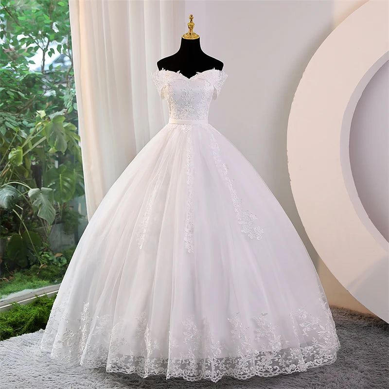 Full-length front shot of the pearl-embellished plus size off-shoulder wedding dress, rendered in a romantic soft blush pink color option for alternative bridal styling.