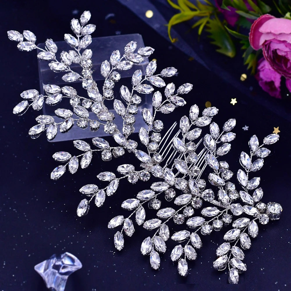 High-angle shot of a flexible silver rhinestone bridal hair comb featuring a multi-branched leaf spray layout over a dark background.