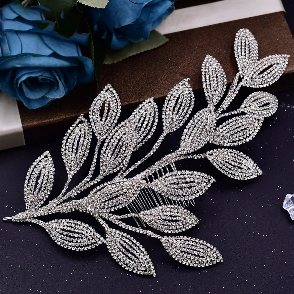 Close-up view of a silver-plated wedding hair accessory designed with texturized pave-set rhinestone hollow leaves and an integrated hair comb.