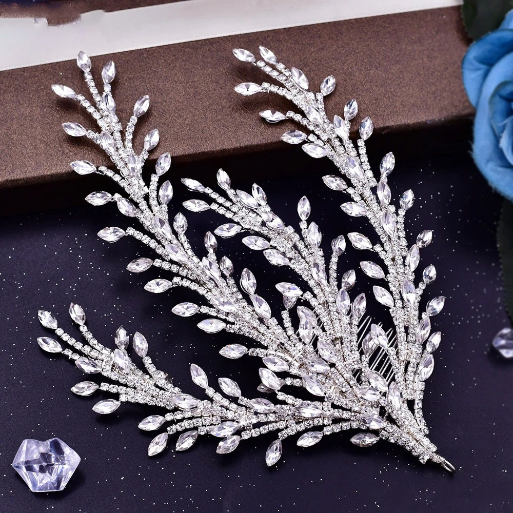 Close-up product view of a flexible multi-branch silver bridal hair comb, displaying elongated rhinestones that mimic delicate botanical branches.