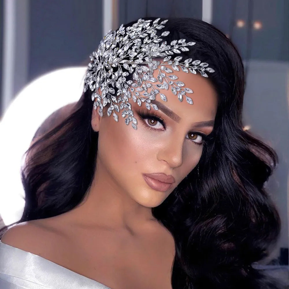 Wide overhead view of a large silver crystal bridal hair comb branch displaying widespread rhinestone sprigs and a central floral wire motif.