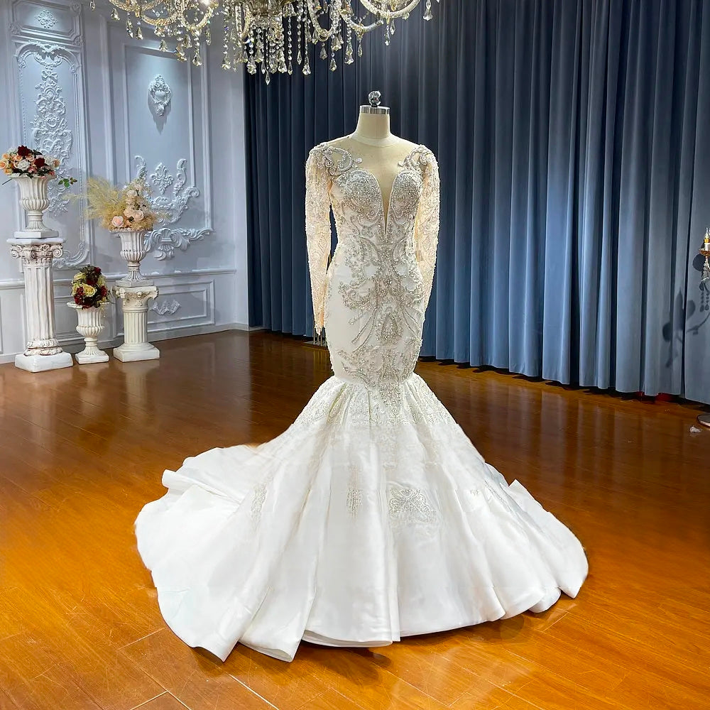 Three-quarter back profile of the mermaid bridal gown, showcasing the fitted silhouette and the dramatic spread of the wide satin train.