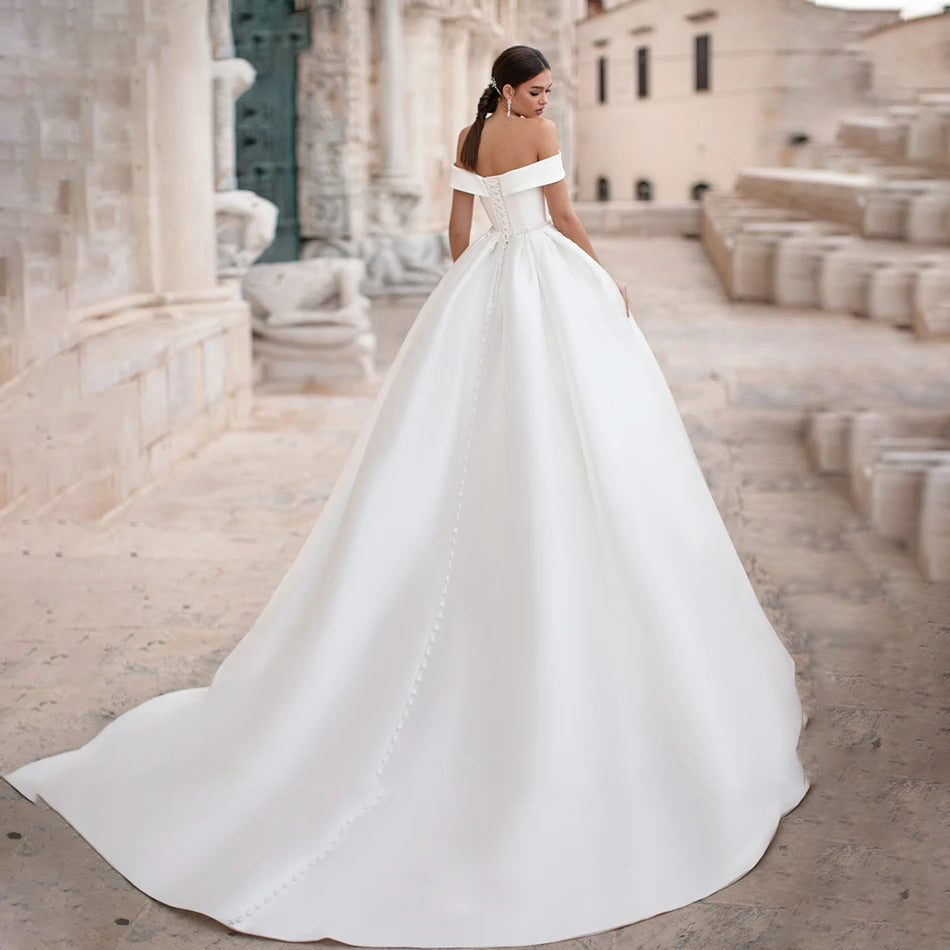 Stunning rear view of the satin wedding dress featuring a lace-up back closure, delicate buttons, and a sweeping train.
