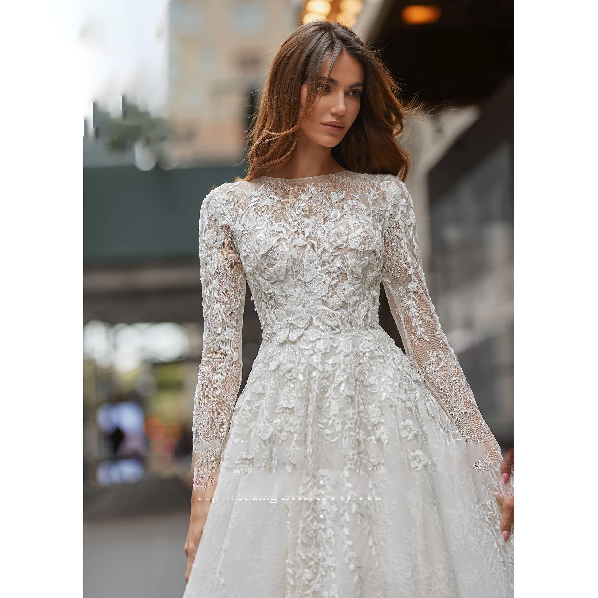 Close-up of an elegant sequined wedding dress bodice with long sleeves and delicate lace embroidery.