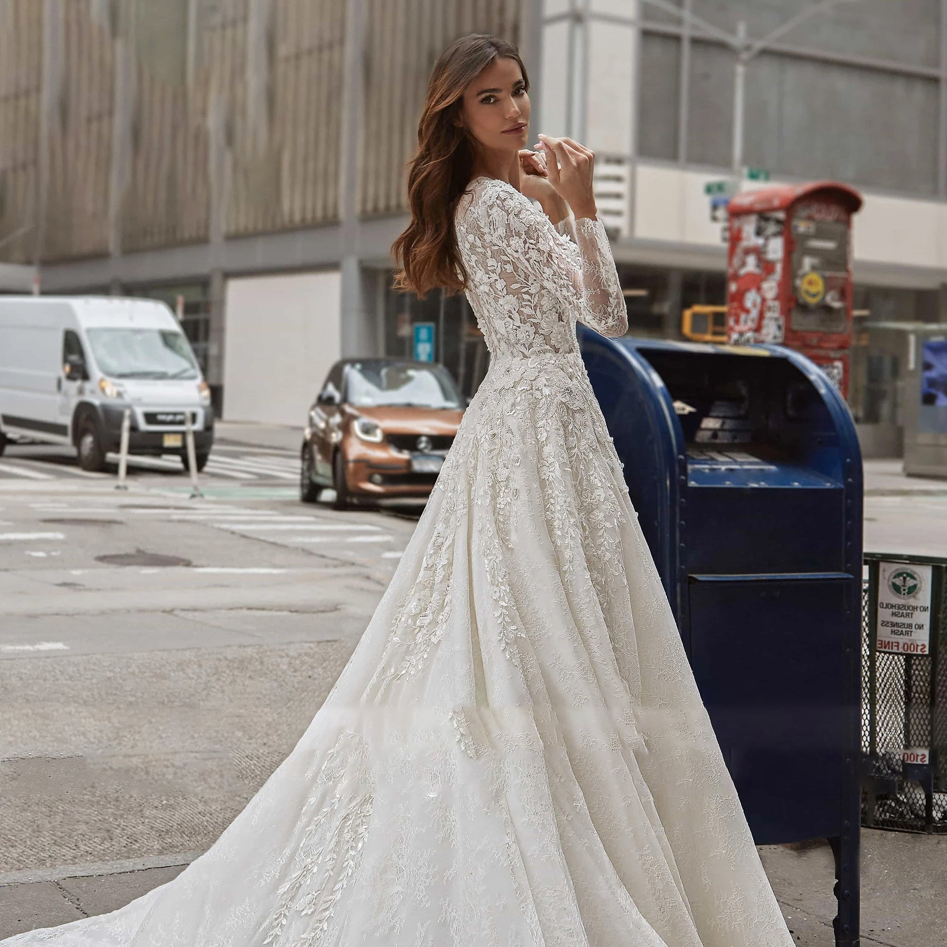 Sophisticated A-line bridal gown with long sleeves and a beautiful flowing silhouette, designed with sparkling sequin embellishments.