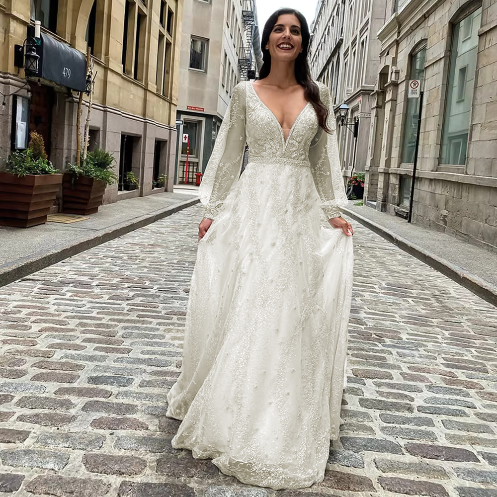 Full-length front view of the crystal beaded long sleeve wedding dress variant, showcased in a warm ivory or soft champagne hue option.