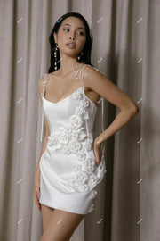 Elegant short white satin wedding dress featuring delicate spaghetti straps and romantic 3D floral rose appliques cascading down the side.