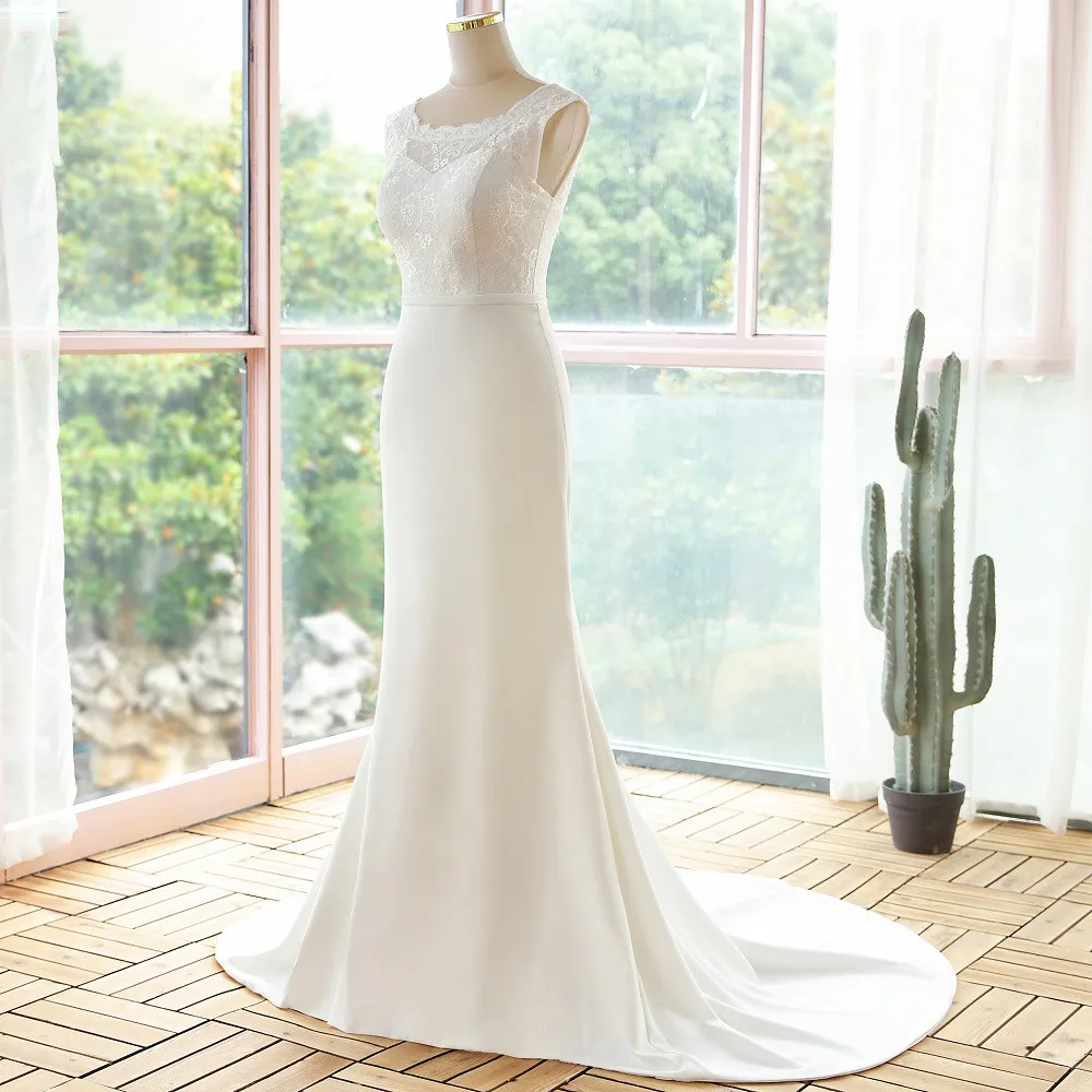 Mannequin display showcasing the front silhouette of a simple lace sleeveless mermaid wedding dress with a delicate lace bodice.