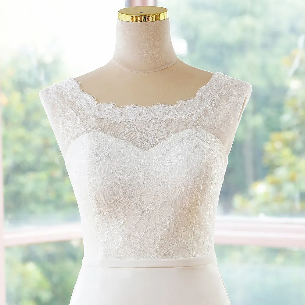Elegant close-up of the intricate lace embellishment on the bodice of a sleeveless mermaid bridal gown.