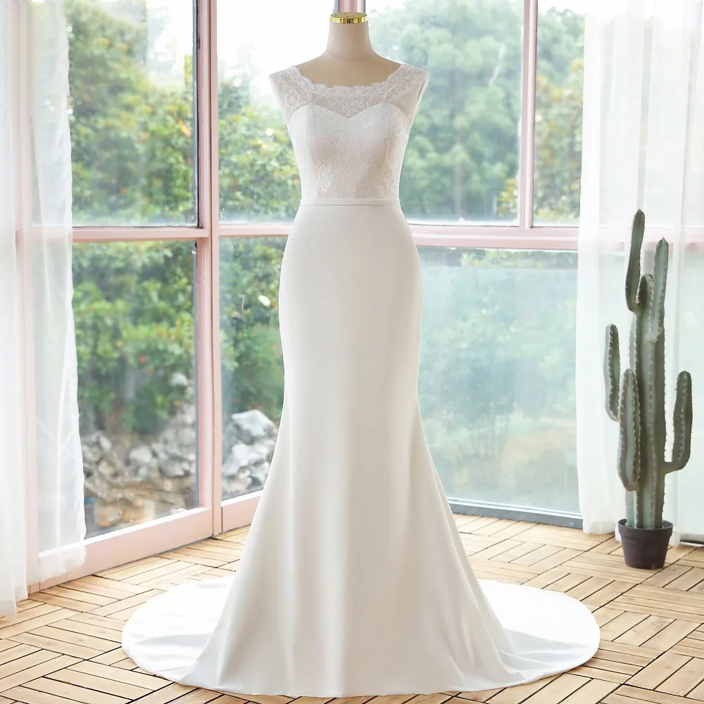 Side view of a mannequin wearing a simple lace sleeveless mermaid wedding dress, focusing on the refined, slim-fit silhouette.