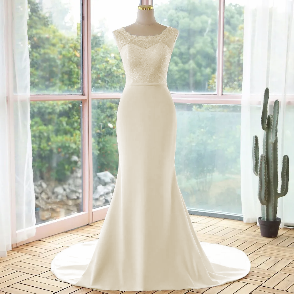 Studio view of a simple lace sleeveless mermaid wedding dress in an off-white tone, showcased on a mannequin.