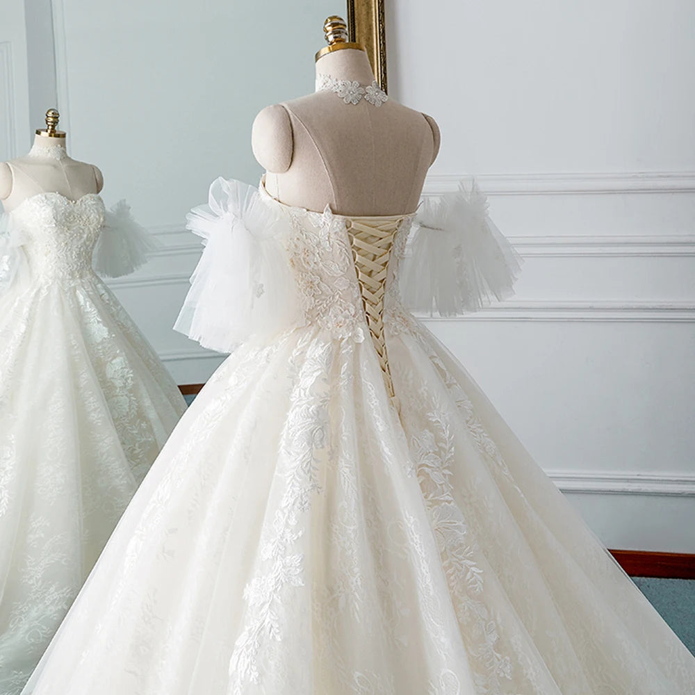 Front profile of an A-line wedding dress showcasing the sweetheart neckline, beaded bodice, and detachable sleeves on a mannequin.