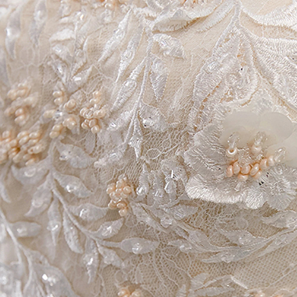 Rear view of an A-line wedding gown highlighting the lace-up corset back and detachable sleeve design.