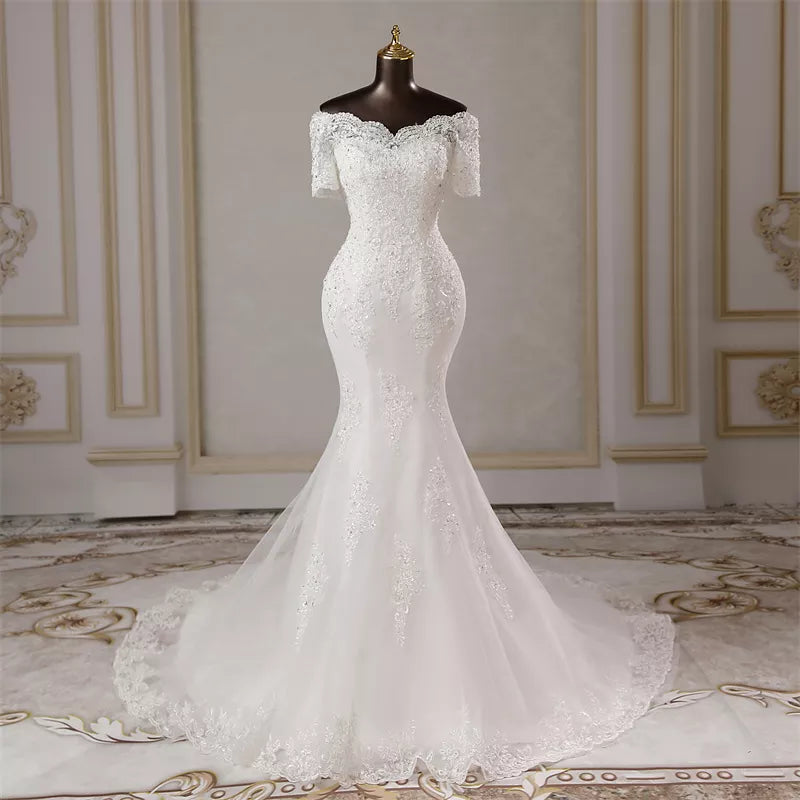 Mannequin display of an elegant sweetheart neck mermaid wedding dress, showcasing the intricate lace bodice and fitted silhouette.