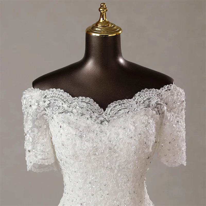 Close-up detail of the off-the-shoulder sweetheart neckline, highlighting the premium lace appliques and subtle sparkle on the bodice.