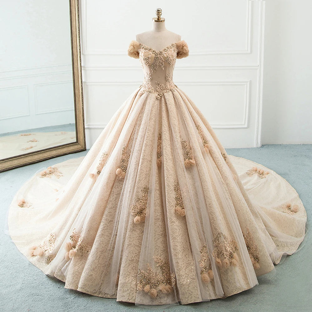 Studio display of a sophisticated A-line ball gown wedding dress with off-the-shoulder floral sleeves and detailed lace embroidery.