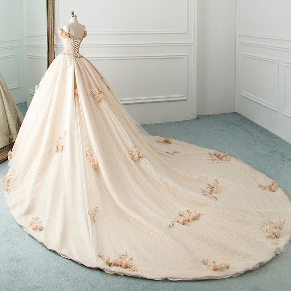 Back view of a stunning tulle ball gown wedding dress with a long train, featuring handmade floral embellishments and a lace-up corset back.