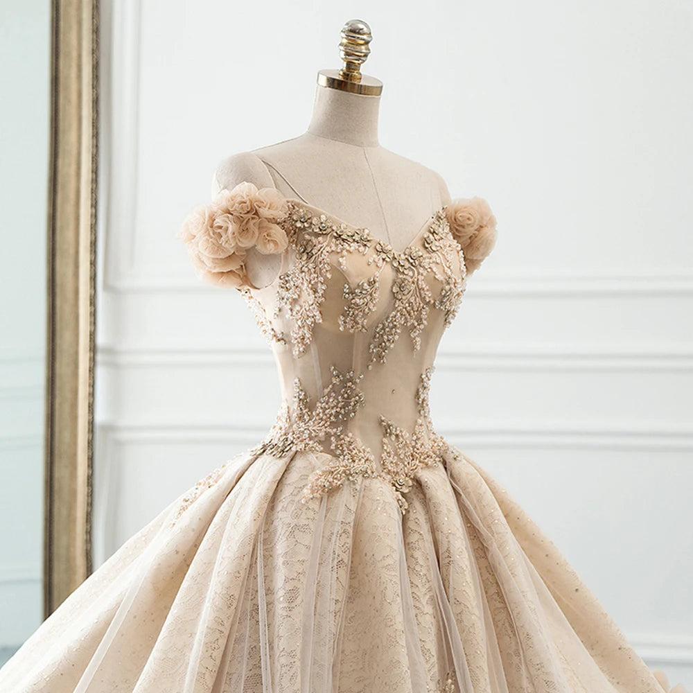 Close-up of a luxury bridal bodice featuring off-the-shoulder handmade floral sleeves and intricate sequin lace detailing.