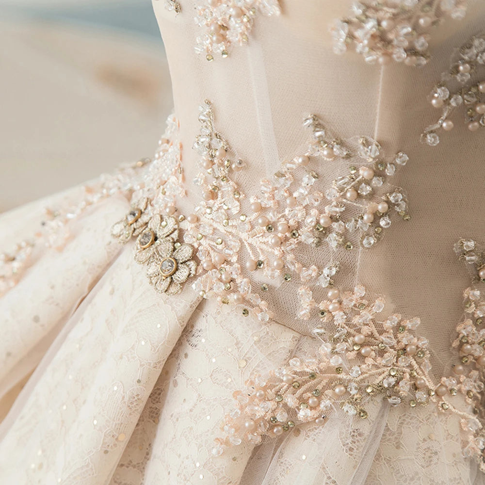 Macro detail shot of delicate lace embroidery, handmade floral appliqués, and sparkling beadwork on a luxury wedding gown.