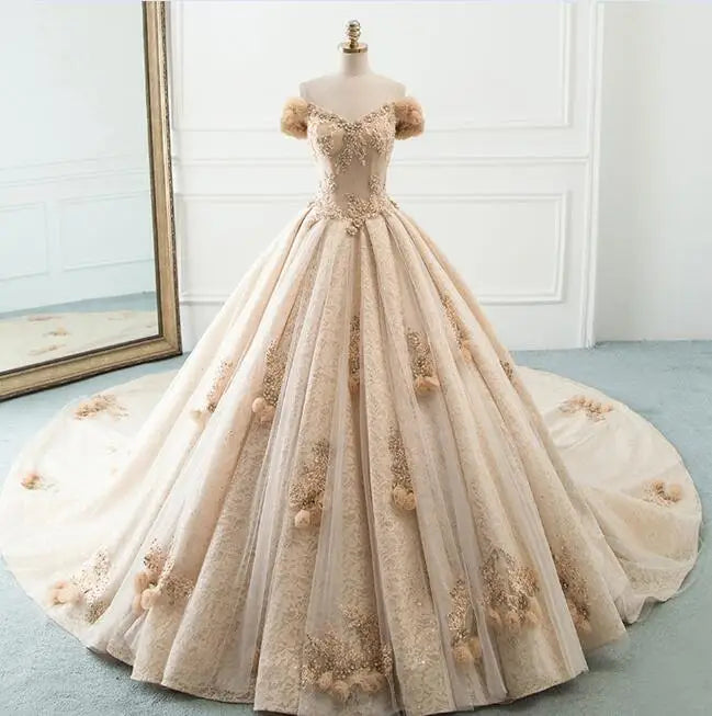 Mannequin showcasing a luxury tulle ball gown wedding dress with handmade floral shoulder details and an expansive A-line skirt.