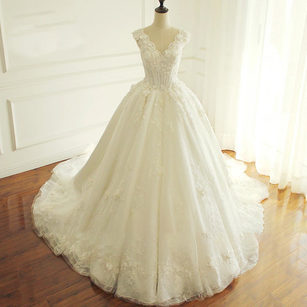 A mannequin displaying the back view of a luxury A-line princess bridal gown, featuring an elegant open back, intricate floral lace, and a graceful train.