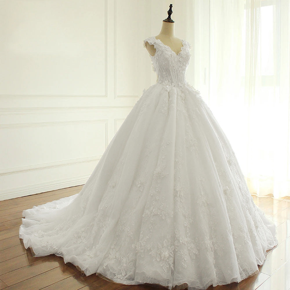 Close-up of the bodice on a bridal mannequin, emphasizing the V-neck and delicate flower-themed lace appliques of the princess wedding dress.
