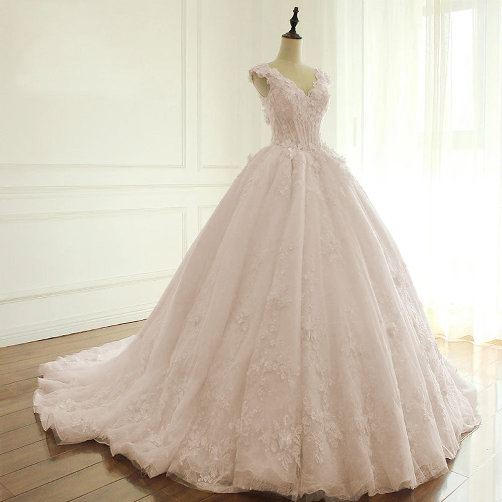 A boutique mannequin displaying an elegant V-neck A-line wedding dress, showcasing the floral lace craftsmanship and luxury bridal style.