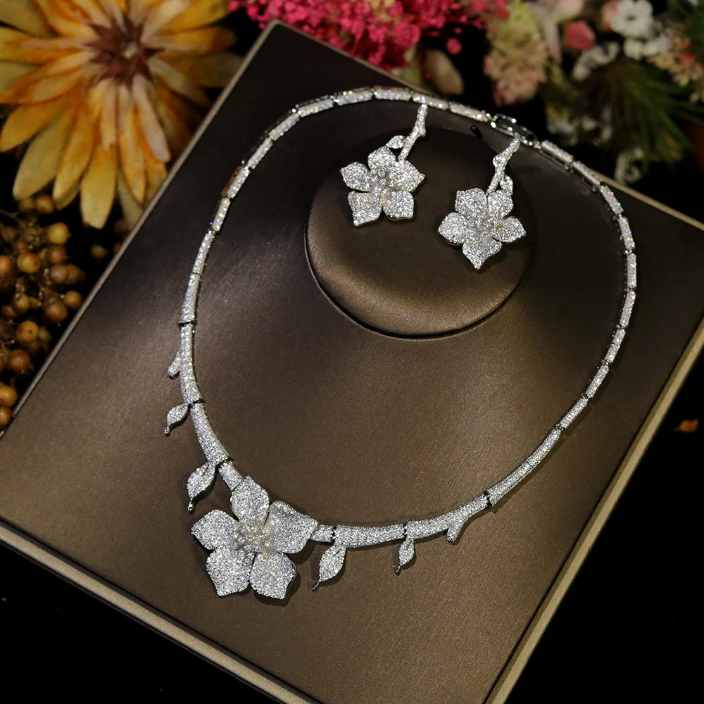 Full product display of white flower CZ bridal necklace and matching floral earrings