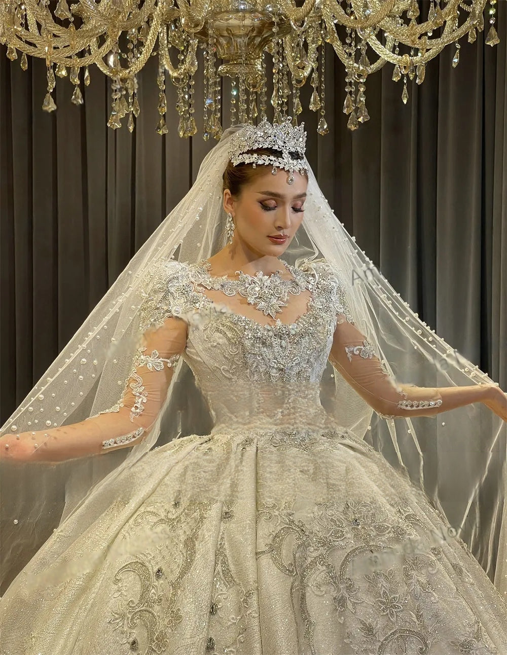 Side profile of a luxury empire bridal gown highlighting the extraordinary shimmer of the crystal-beaded fabric and the majestic scale of the voluminous skirt.