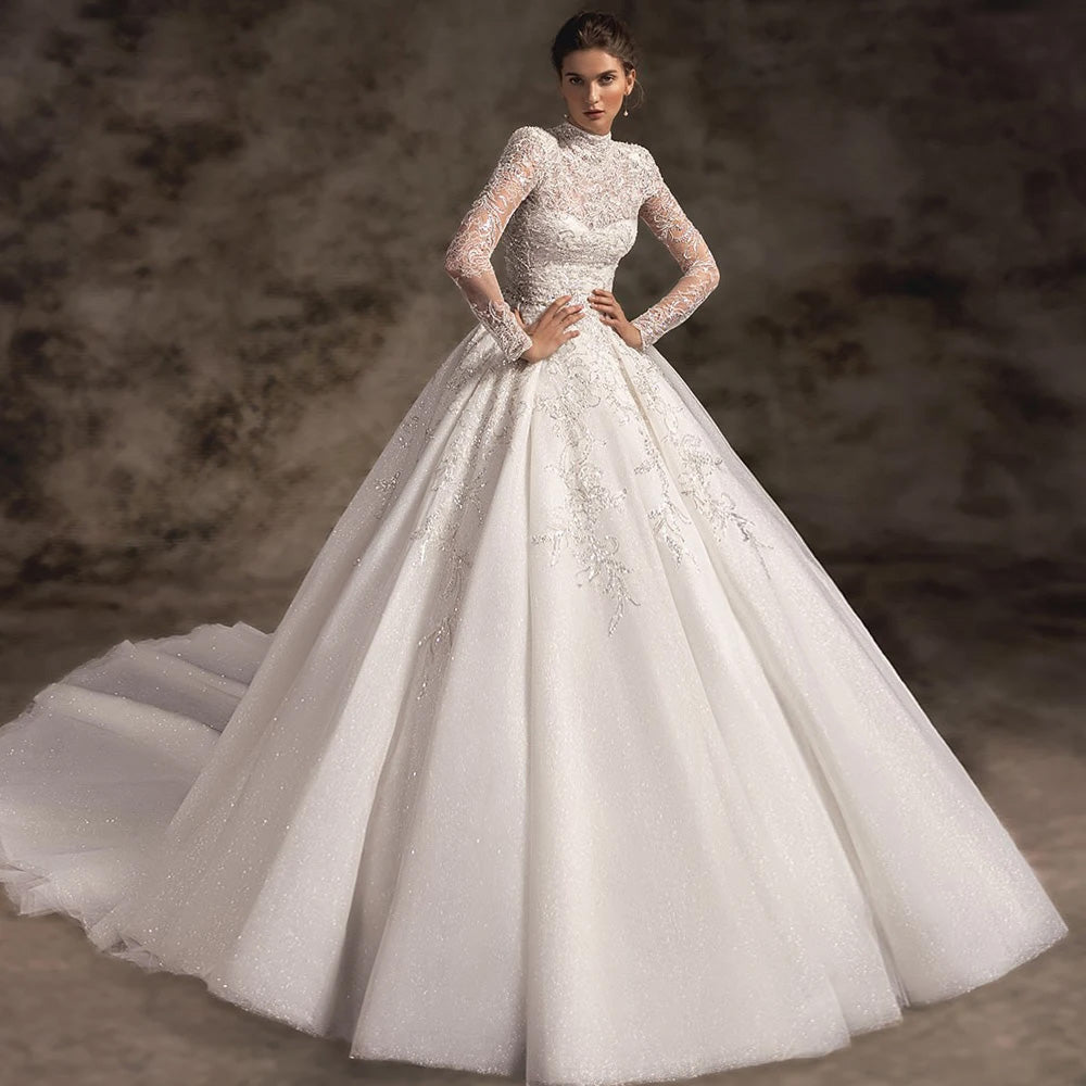 Close-up portrait of a bride wearing a backless A-line wedding dress with lace bodice detailing.