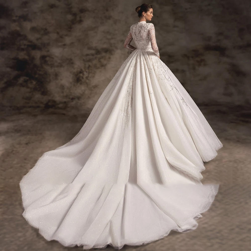 Elegant back view of a luxury backless A-line bridal gown, showcasing detailed lace appliques and a grand royal train.