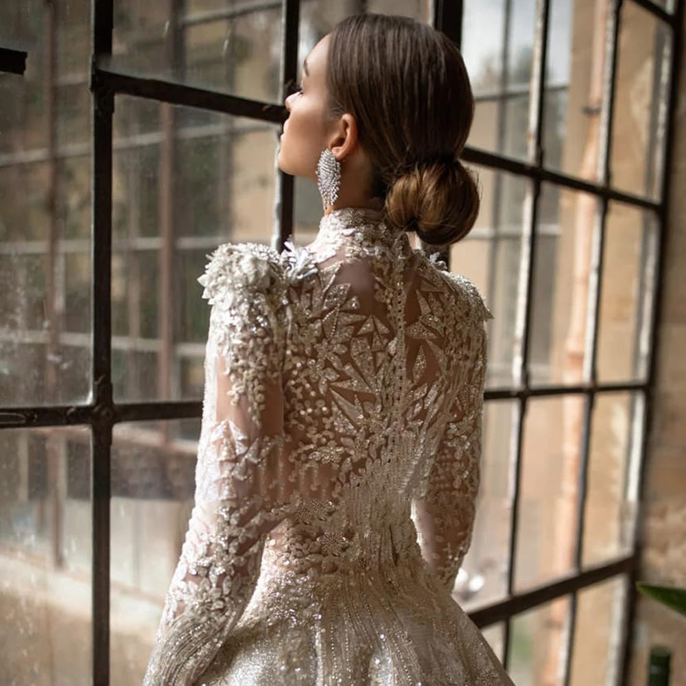 Detailed portrait of the back of a luxury lace bridal gown, highlighting the high neck design, intricate lace appliques, and elegant long sleeves.
