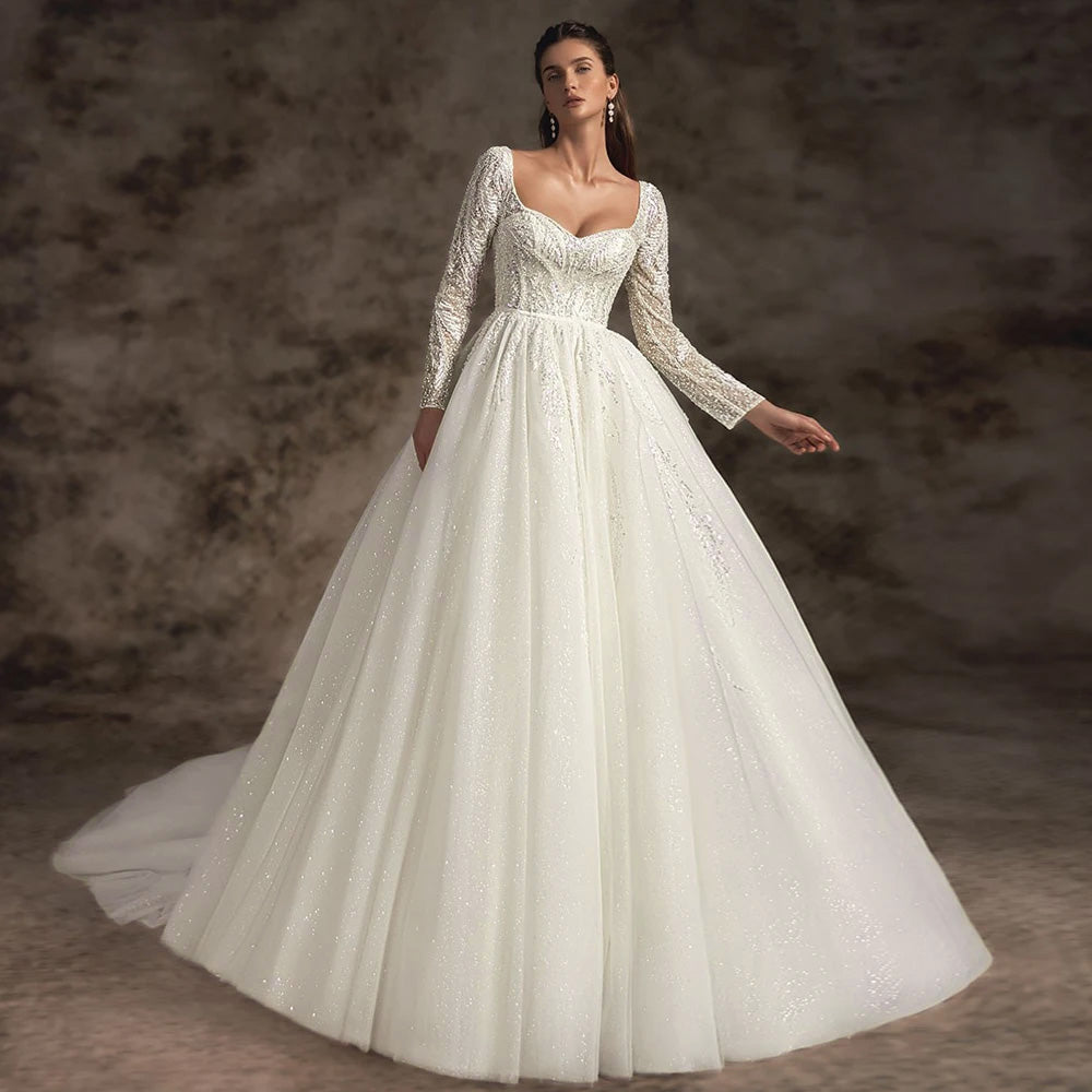 Full-length view of a bride wearing a sexy backless V-neck wedding dress with elegant lace appliques, intricate flowers, and a long chapel train.