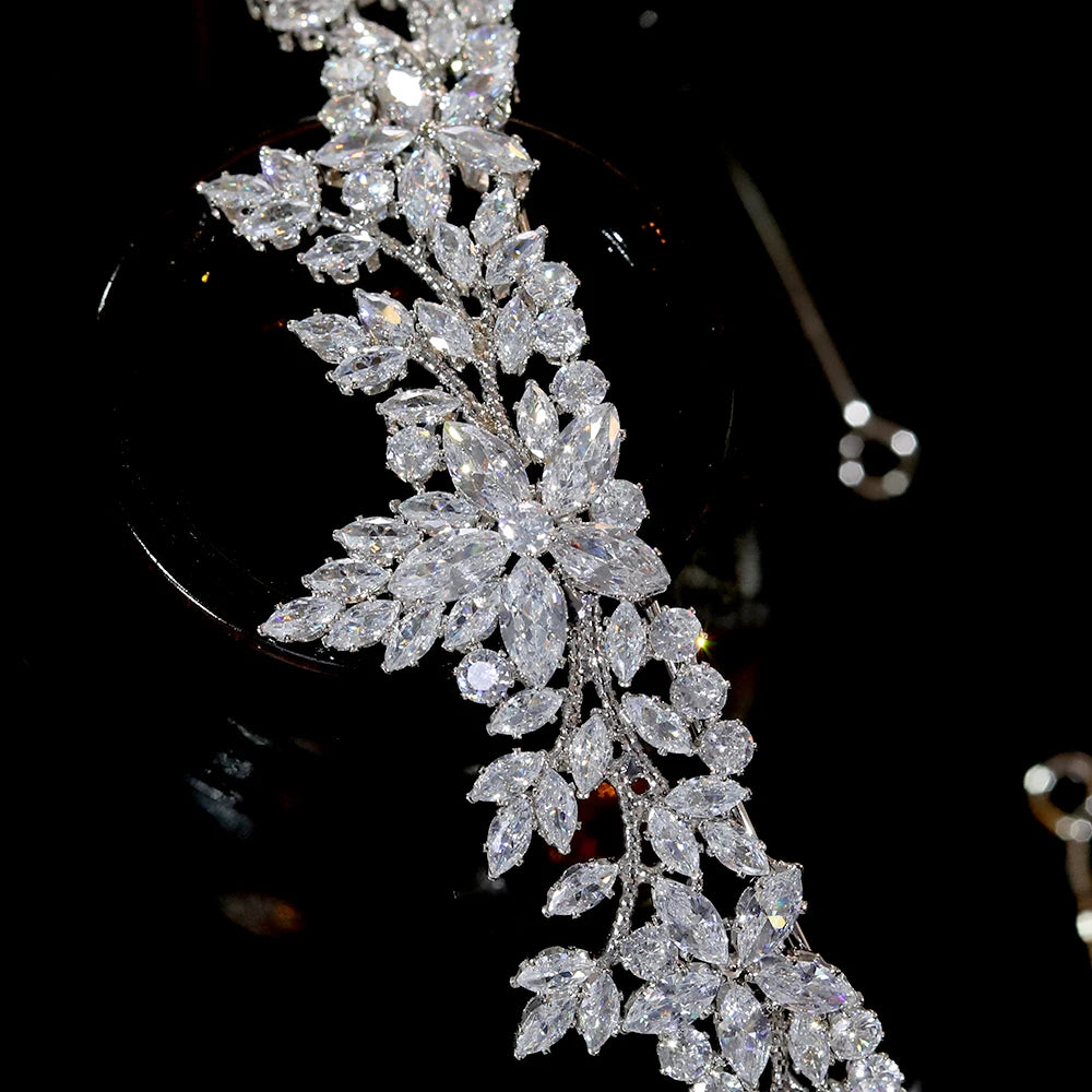 Close-up macro photograph highlighting the detailed marquise-cut crystal floral setting on a premium bridal tiara crown.