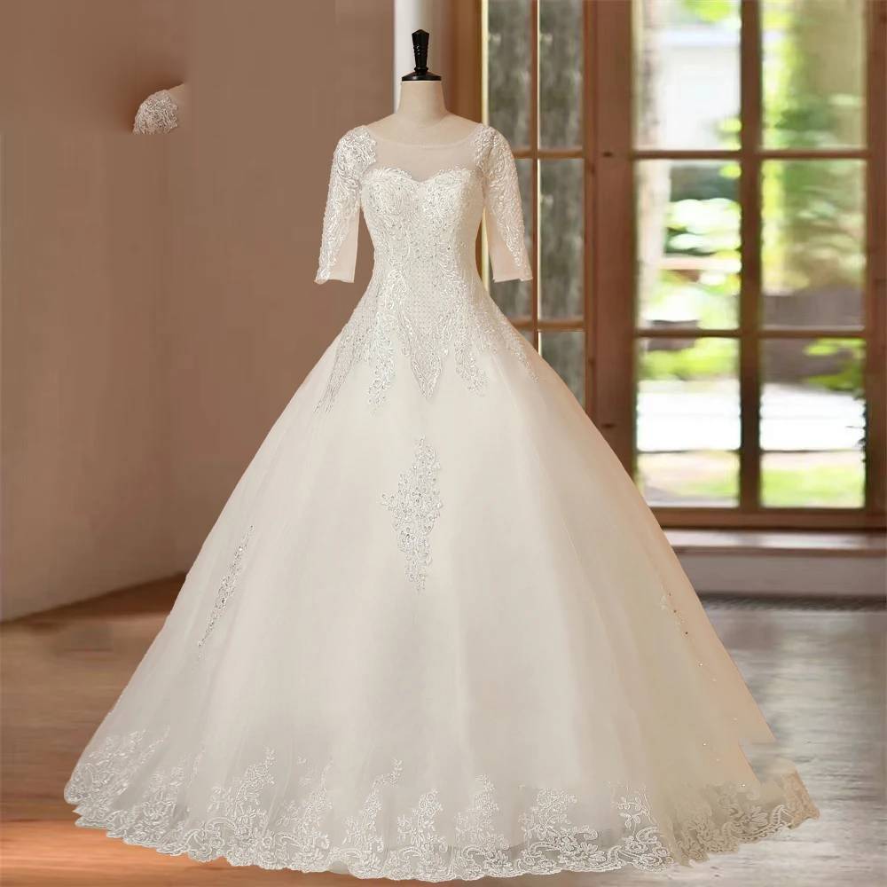 Full front view of an elegant floor-length bridal gown with half sleeves and lace details, perfect for a classic wedding look.